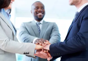 divorce mediation concept with mediator joining hands with couple