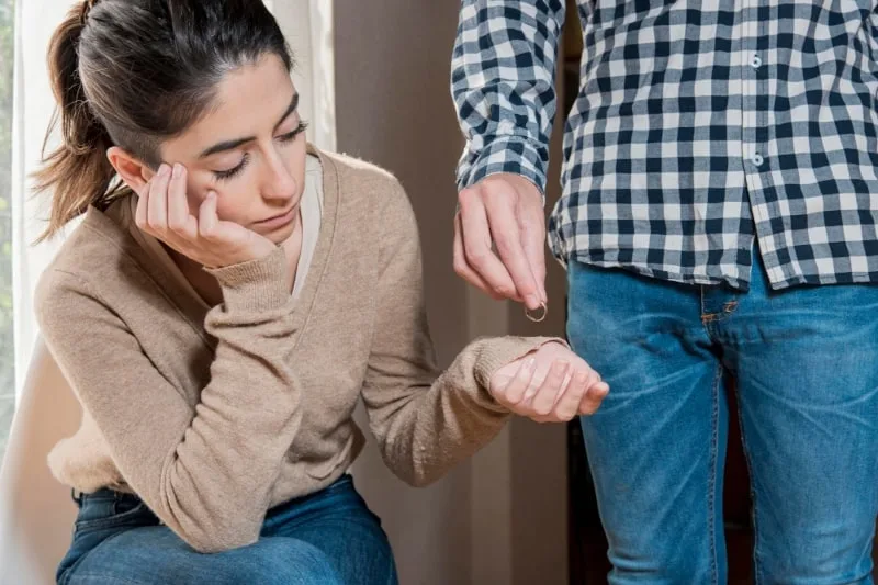 short term marriage concept of husband returning wedding ring to wife