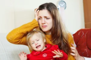 child support concept of upset mother with child after learning her child support modification was denied